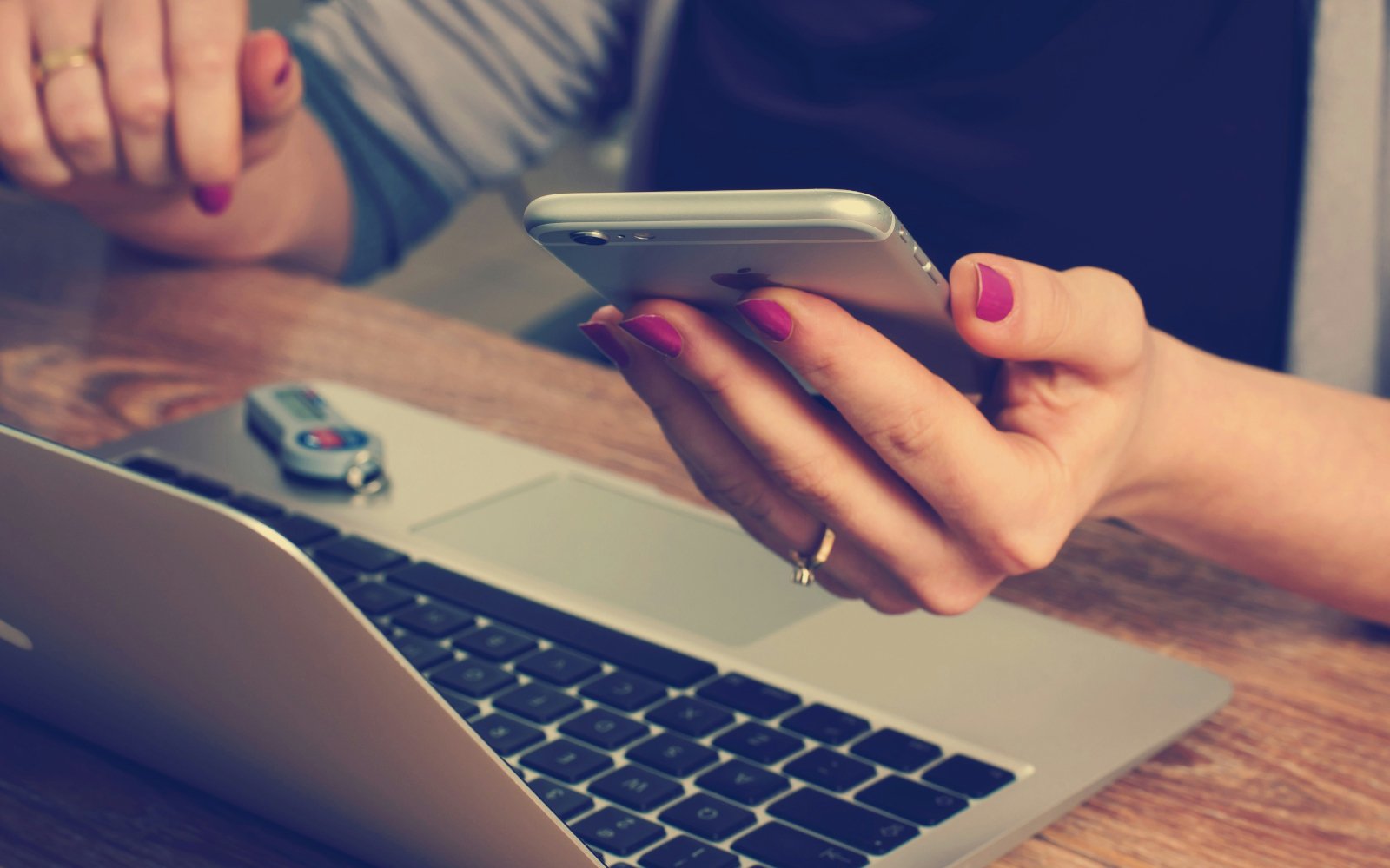 Customer using a phone and laptop to order online